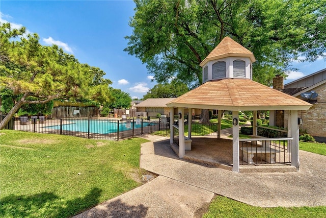 community pool with a gazebo, fence, a lawn, and a patio