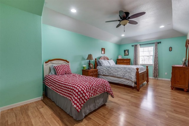 bedroom featuring baseboards, light wood finished floors, a ceiling fan, and vaulted ceiling