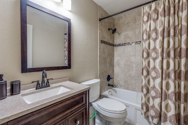 bathroom with vanity, toilet, a textured wall, and shower / bath combo with shower curtain