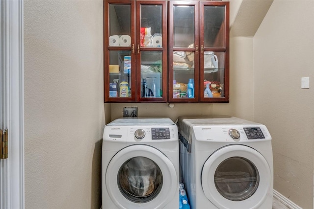 laundry area with cabinet space and washer and clothes dryer