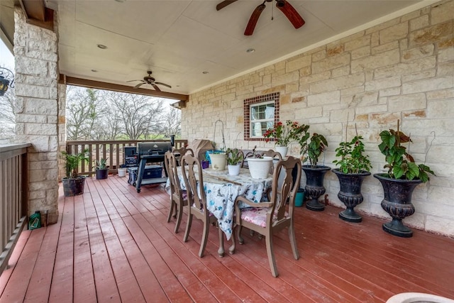 deck with grilling area, ceiling fan, and outdoor dining space