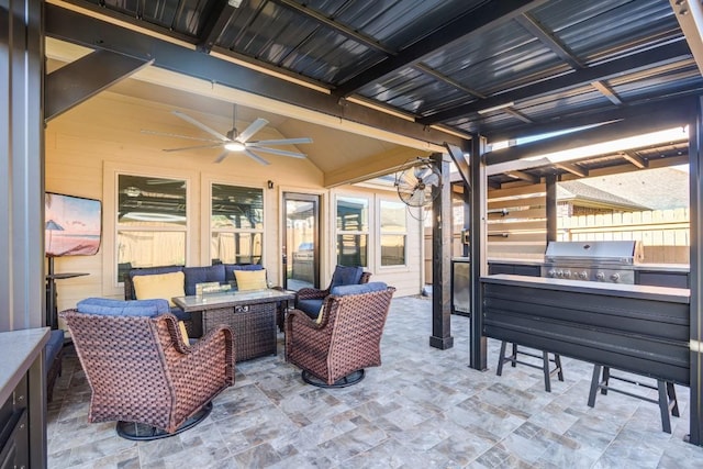 view of patio featuring grilling area, an outdoor living space, ceiling fan, fence, and exterior kitchen