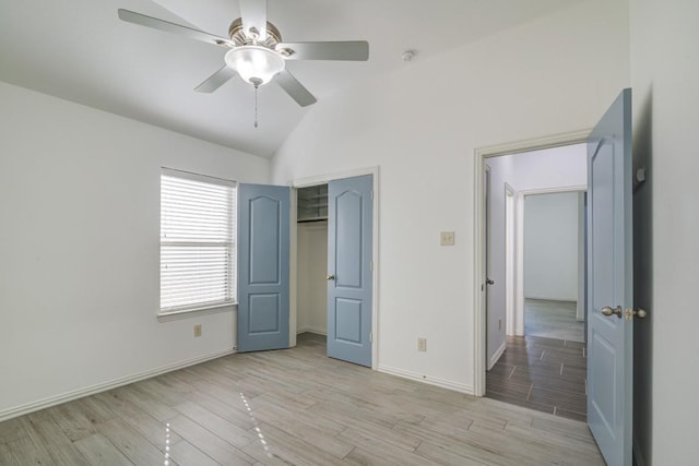 unfurnished bedroom with baseboards, a ceiling fan, light wood-style floors, and vaulted ceiling