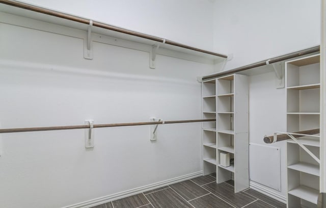 walk in closet featuring wood finish floors