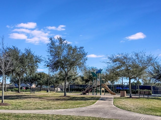 community play area with a yard and fence