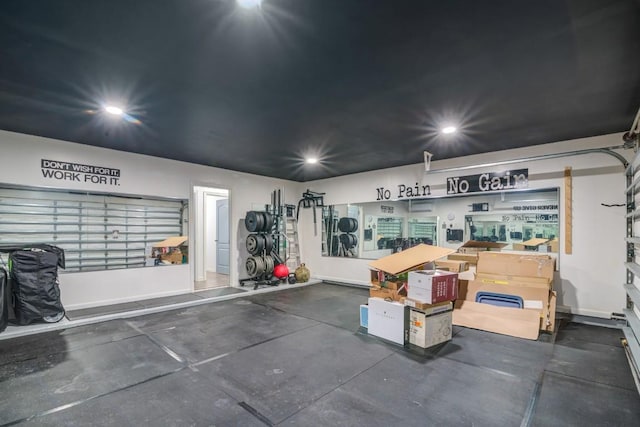 garage with recessed lighting and baseboards