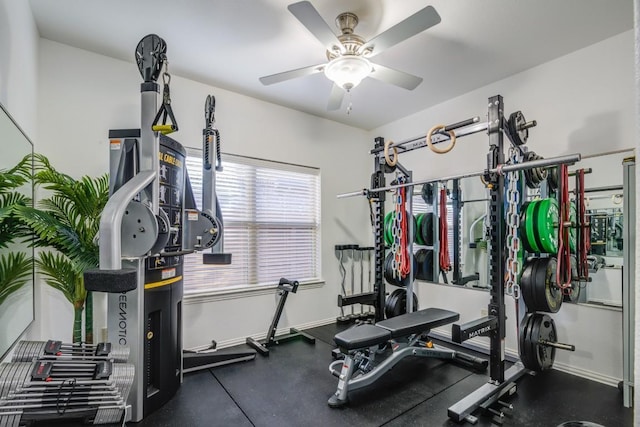 exercise room with baseboards and a ceiling fan