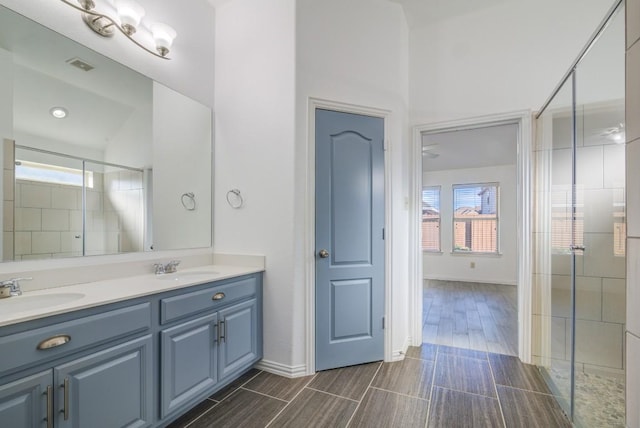 full bathroom featuring a sink, visible vents, a wealth of natural light, and a shower stall