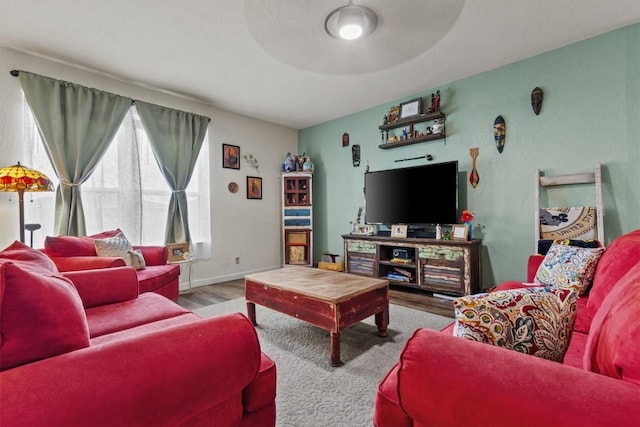 living room with baseboards and wood finished floors