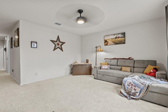 carpeted living area featuring visible vents, baseboards, and ceiling fan