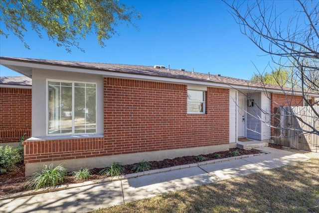 ranch-style home featuring brick siding