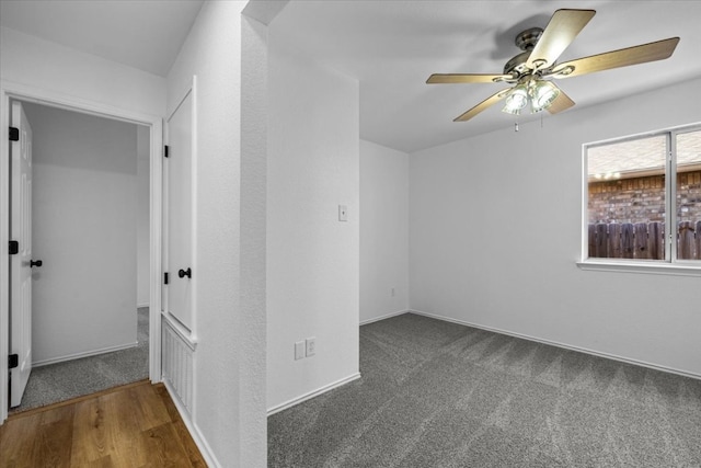 carpeted spare room with baseboards and ceiling fan