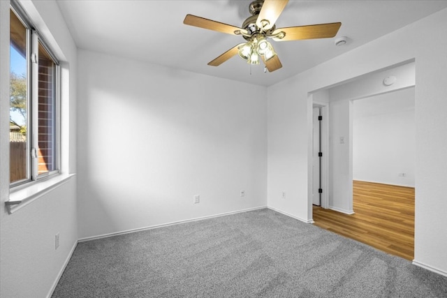 unfurnished room featuring baseboards, ceiling fan, and carpet floors