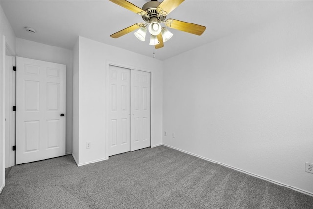 unfurnished bedroom with a closet, baseboards, carpet, and ceiling fan