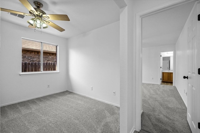 empty room featuring visible vents, baseboards, ceiling fan, and carpet flooring