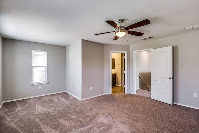 unfurnished bedroom featuring visible vents, baseboards, and carpet floors