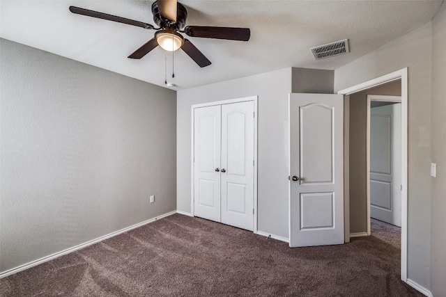 unfurnished bedroom with baseboards, visible vents, carpet floors, ceiling fan, and a closet