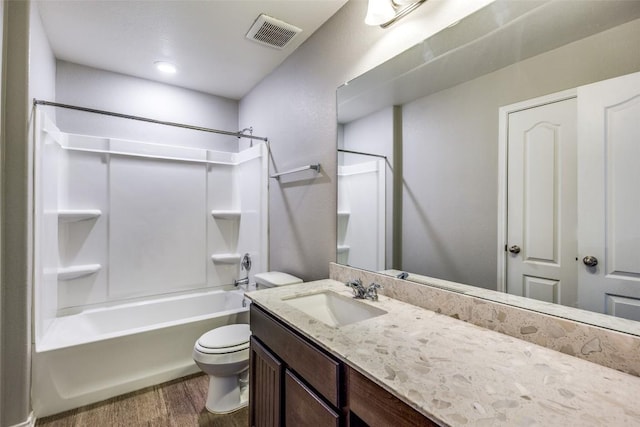 bathroom with visible vents, toilet, wood finished floors, bathtub / shower combination, and vanity