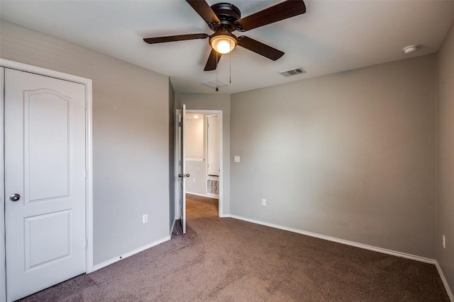 unfurnished bedroom with visible vents, carpet floors, baseboards, and ceiling fan