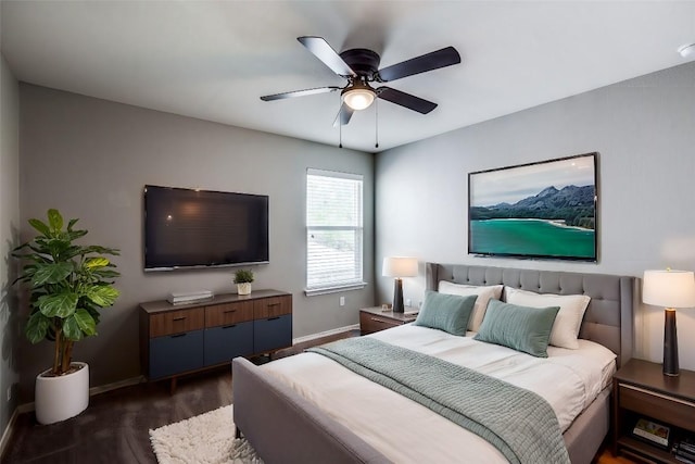 bedroom featuring baseboards, dark wood-style floors, and a ceiling fan