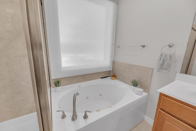 full bath featuring a tub with jets and vanity