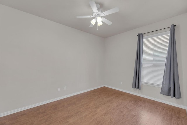 unfurnished room featuring baseboards, ceiling fan, and light wood finished floors