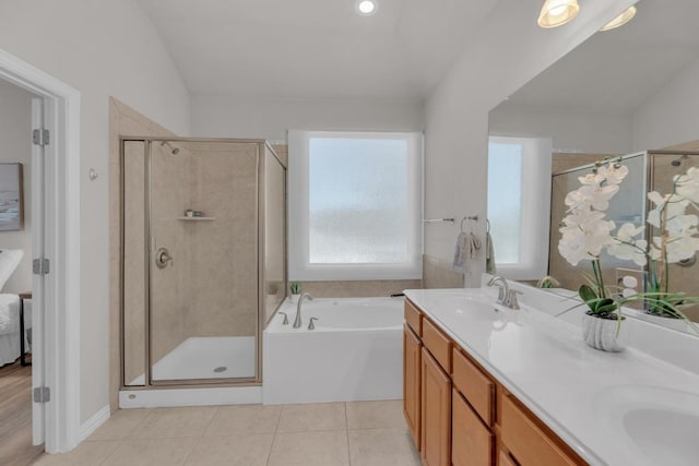 bathroom with tile patterned floors, a stall shower, a sink, double vanity, and a bath