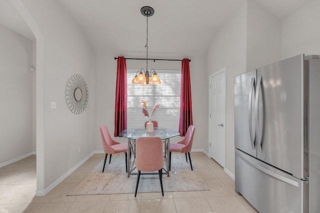 dining room with vaulted ceiling, light tile patterned floors, baseboards, and a chandelier