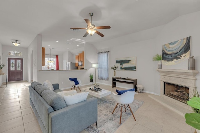 living area with light tile patterned flooring, recessed lighting, a fireplace with raised hearth, and baseboards