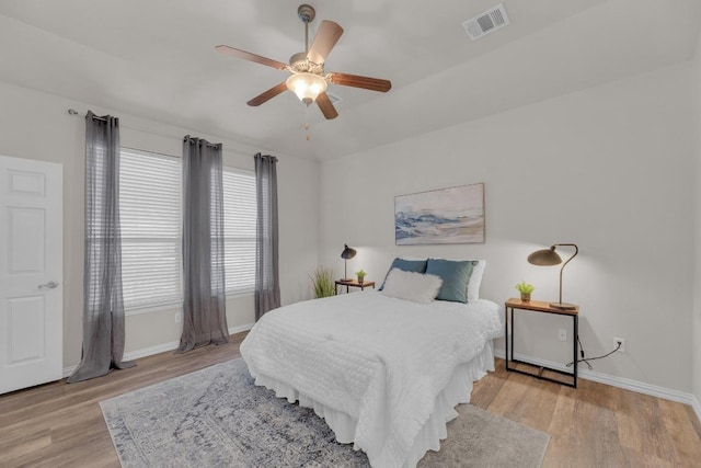 bedroom with visible vents, ceiling fan, baseboards, and light wood-style floors