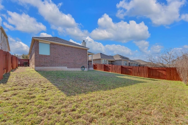 view of yard with a fenced backyard