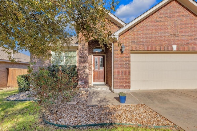 single story home featuring an attached garage, fence, brick siding, and driveway