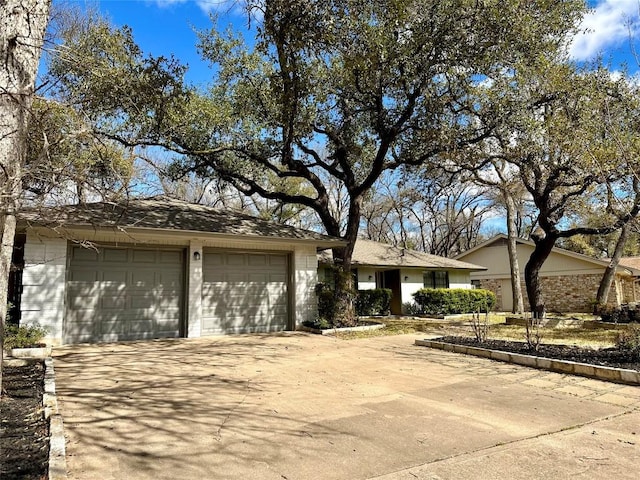 single story home featuring an attached garage and driveway