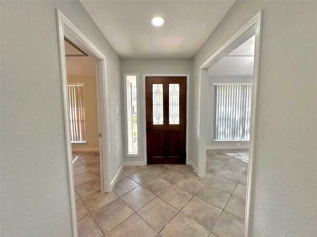 11740 D K Ranch Rd, Austin, TX 78759 - entrance foyer featuring light tile patterned floors and a textured wall