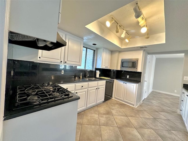 11740 D K Ranch Rd, Austin, TX 78759 - kitchen featuring a raised ceiling, stainless steel microwave, decorative backsplash, and black dishwasher