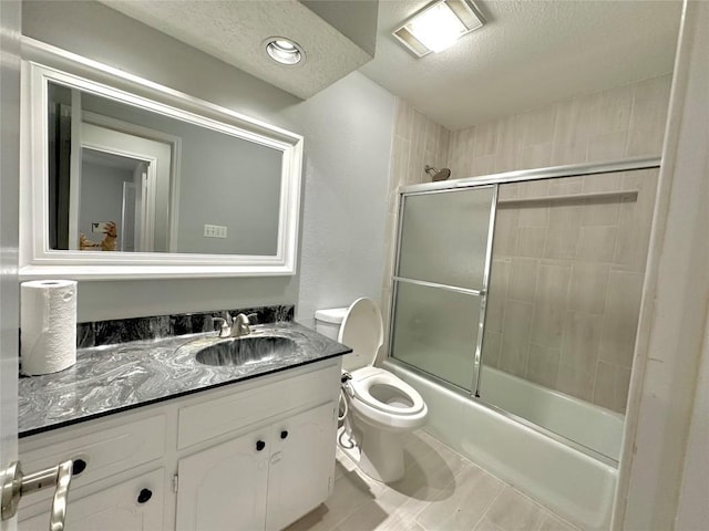 bathroom featuring visible vents, toilet, vanity, enclosed tub / shower combo, and a textured ceiling