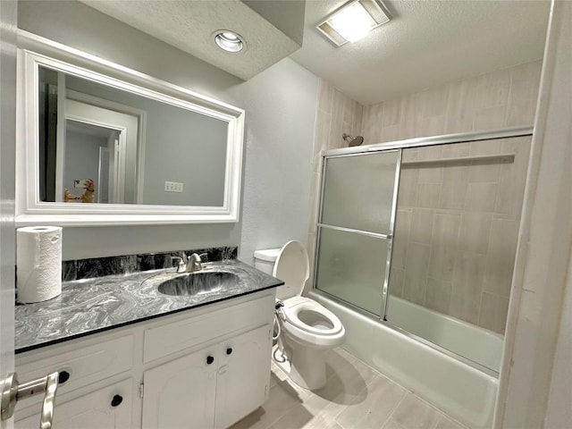 11740 D K Ranch Rd, Austin, TX 78759 - bathroom featuring a textured ceiling, vanity, enclosed tub / shower combo, and tile patterned flooring