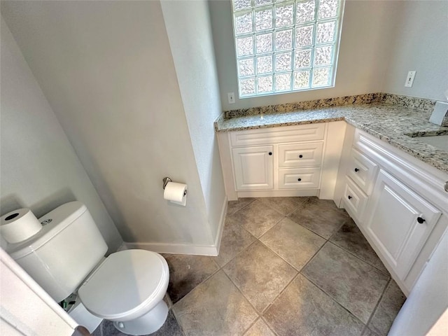 bathroom featuring toilet and baseboards