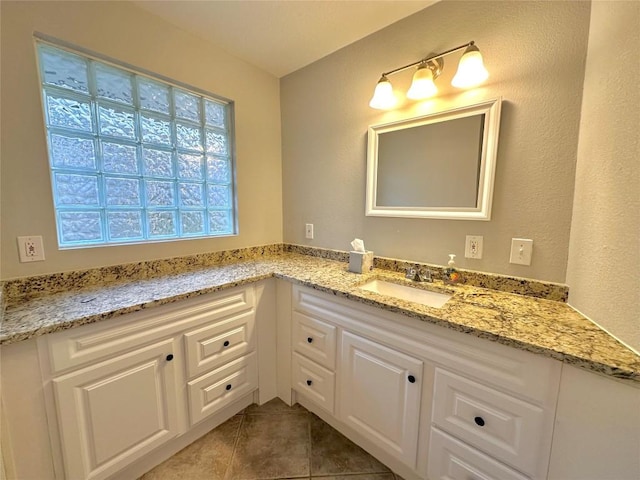 bathroom featuring tile patterned flooring and vanity