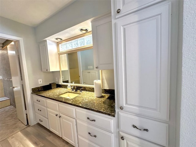 bathroom with vanity and wood finished floors