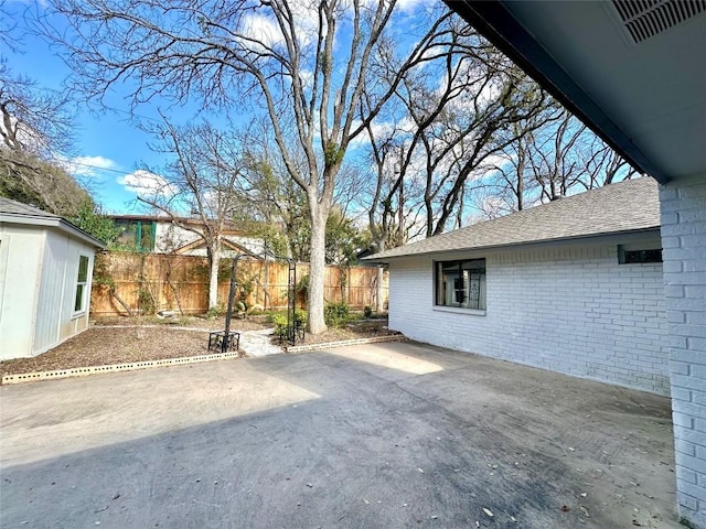 view of patio featuring fence