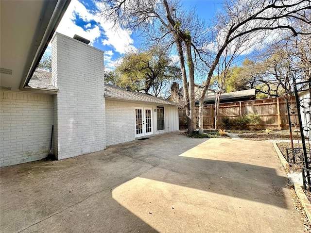 view of patio featuring french doors and fence