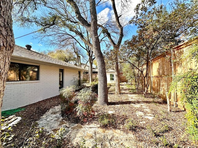 view of yard with an outbuilding and fence