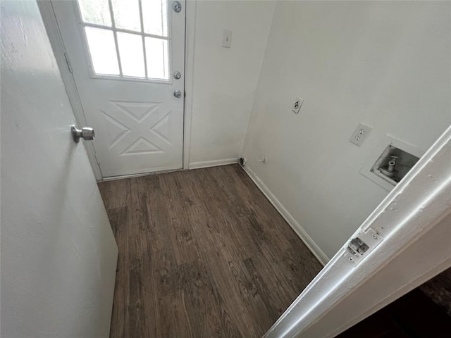 doorway to outside featuring baseboards and wood finished floors