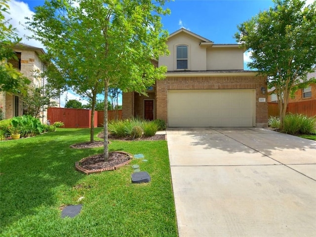 traditional-style home with brick siding, a front lawn, fence, concrete driveway, and a garage