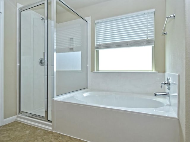 bathroom with tile patterned floors, a stall shower, and a bath