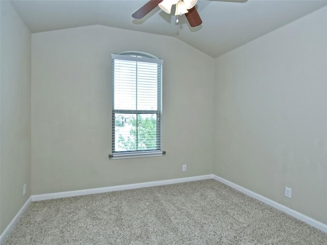 carpeted spare room with ceiling fan, baseboards, and lofted ceiling