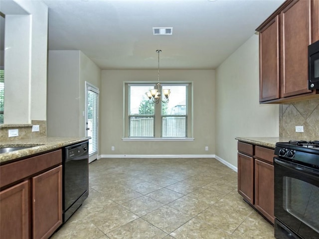 kitchen with visible vents, backsplash, baseboards, light stone counters, and black appliances