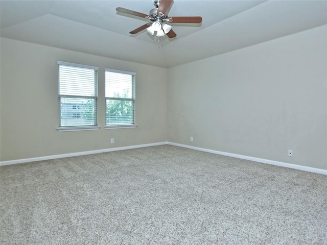 spare room with carpet flooring, a ceiling fan, and baseboards