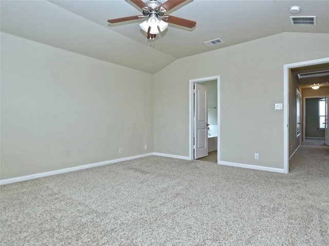 unfurnished bedroom featuring visible vents, carpet flooring, and vaulted ceiling